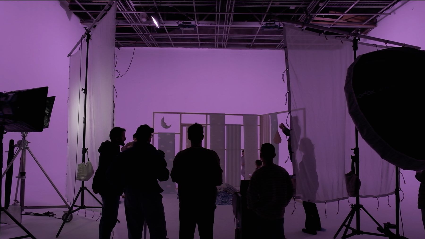 Crew in front of a purple cyclorama